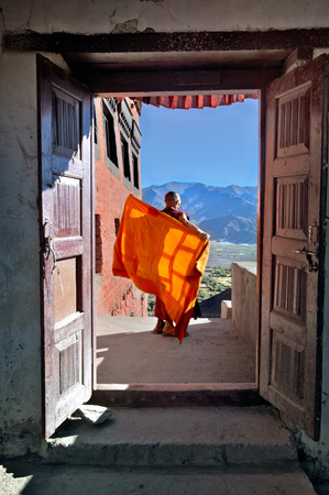 Monk adjusts his upper robe